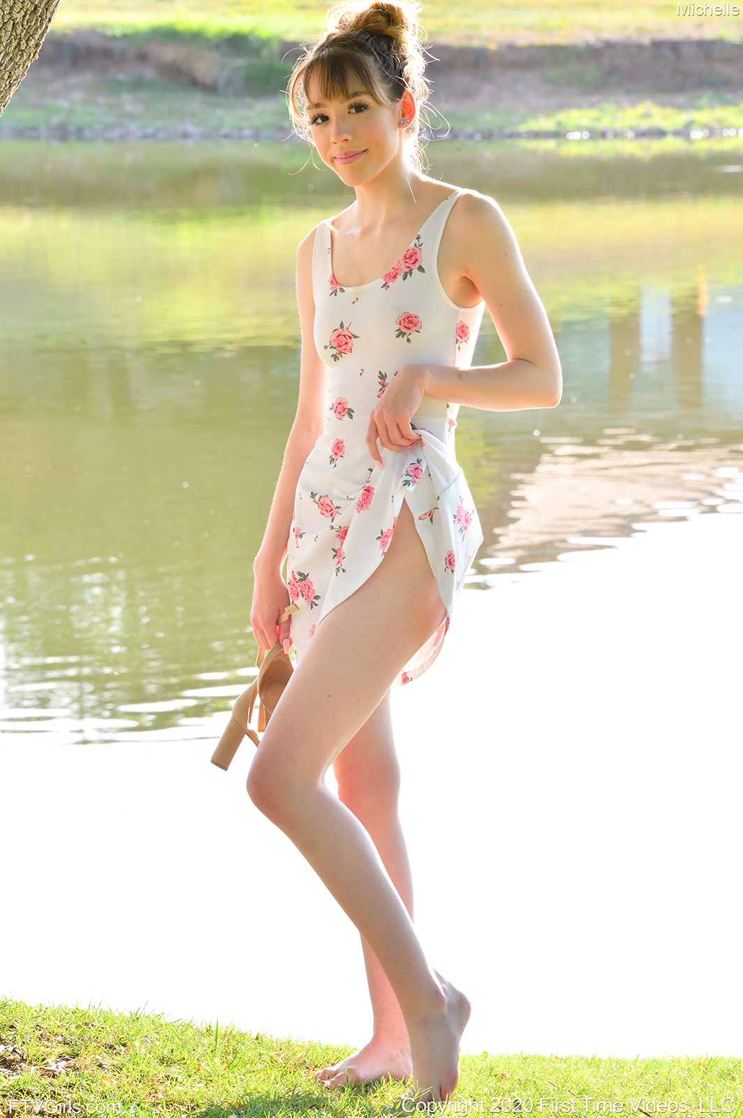 teen pornstar Michelle FTV is wearing a sexy floral skirt non nude while standing near a lake in Morning Teen Beauty